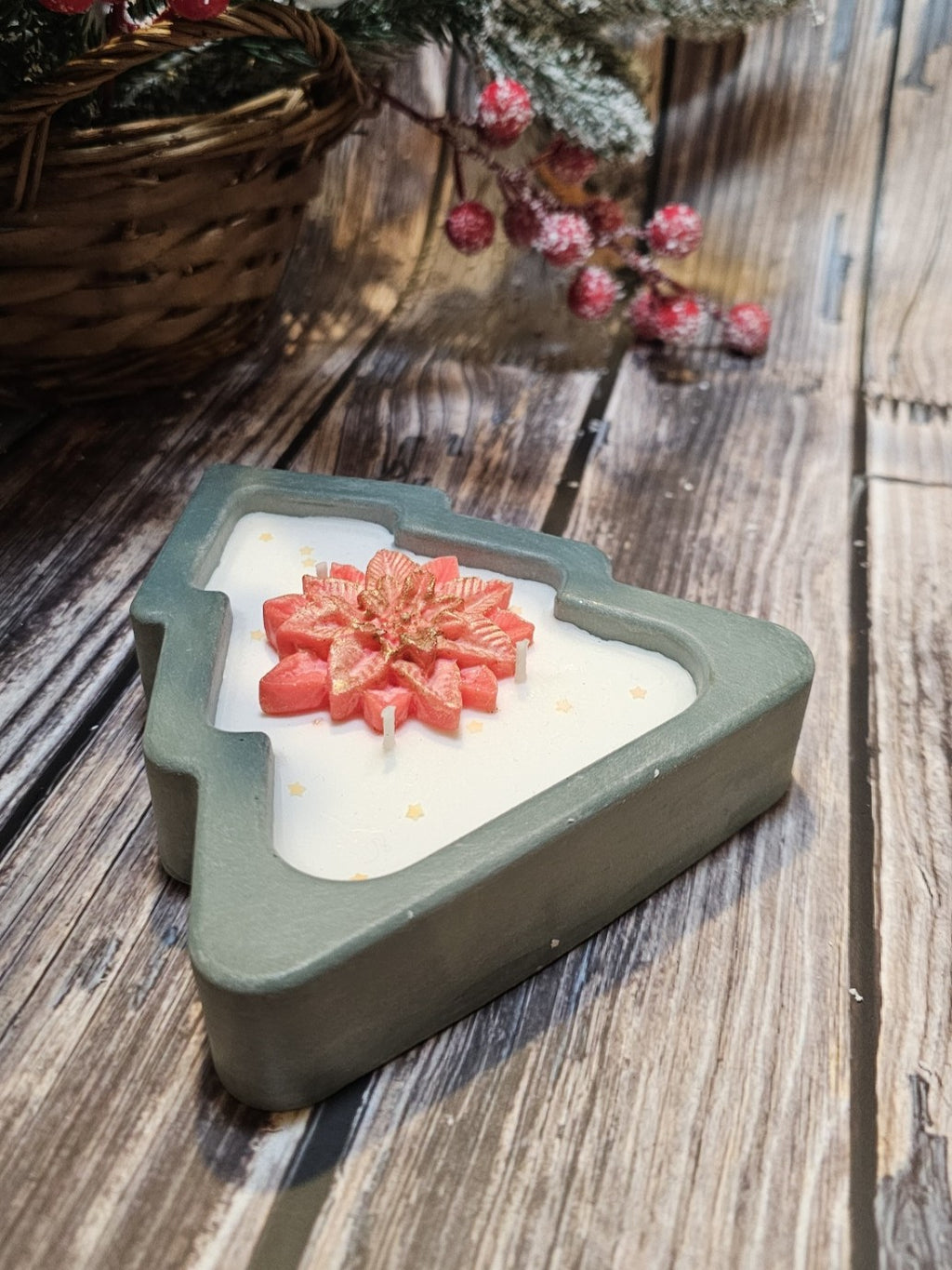 Lit Christmas tree candle with warm glowing cotton wicks, showing handmade texture and festive decorative details.