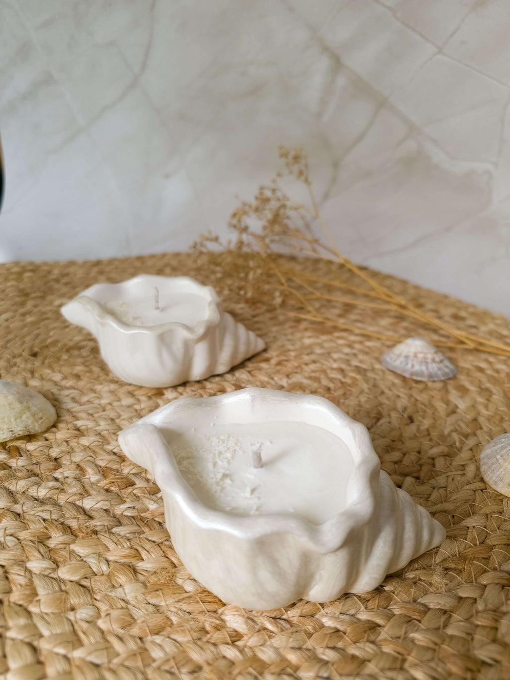 Ocean Breeze Set - Seashell Candle Duo displayed on a natural woven mat with decorative seashells.