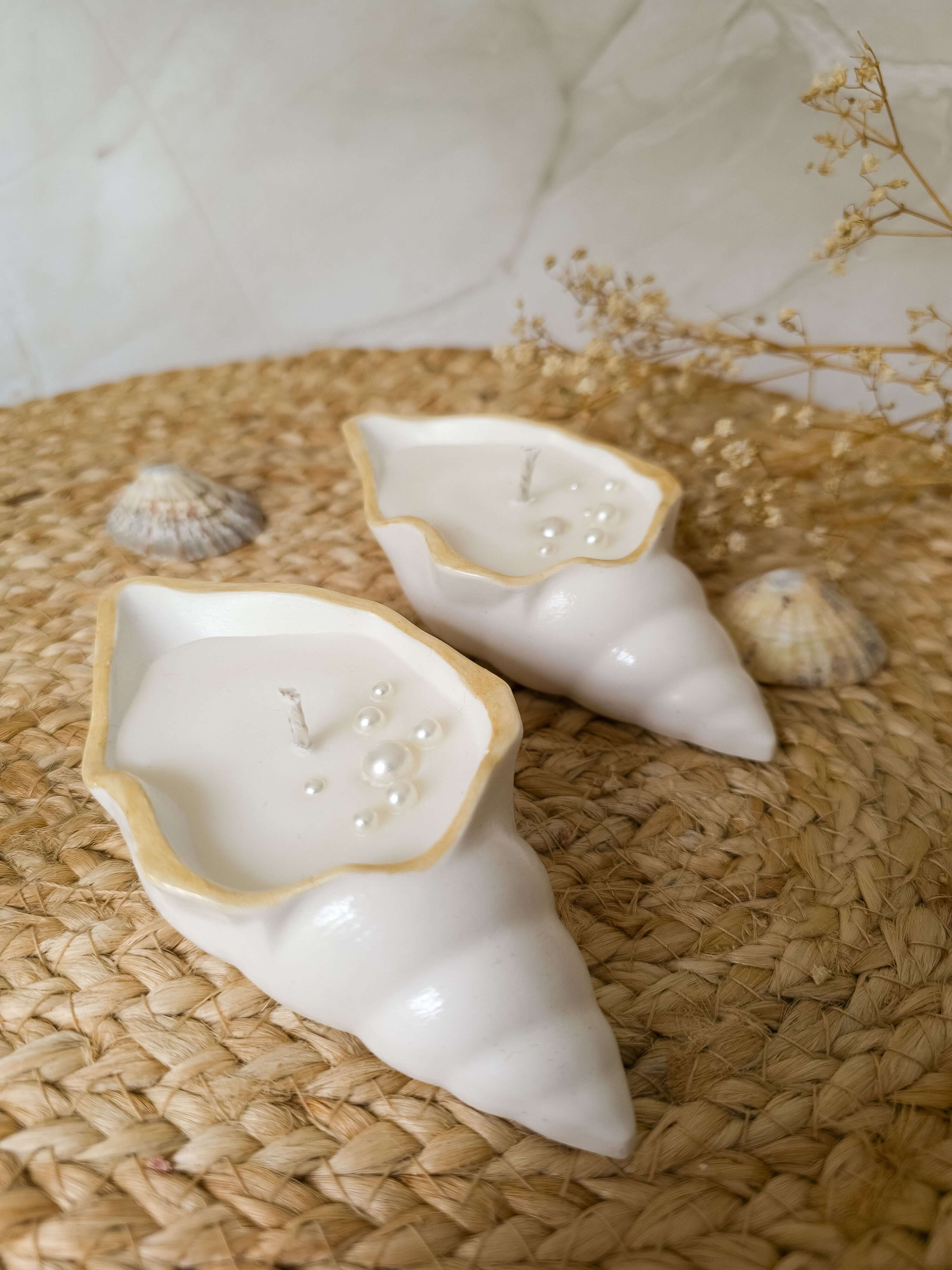 Seashell Gift Set featuring two sculptural candles shaped like elegant white shells with golden rims and pearl accents.